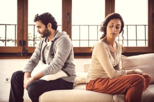 Couple not talking after a fight on the sofa in living room at home